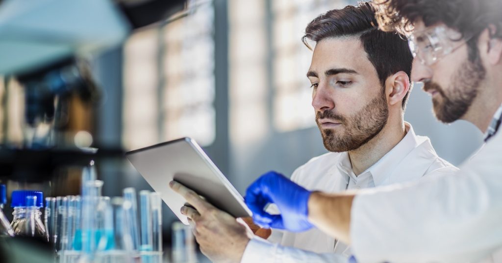 two scientist using digital tablet in laboratory